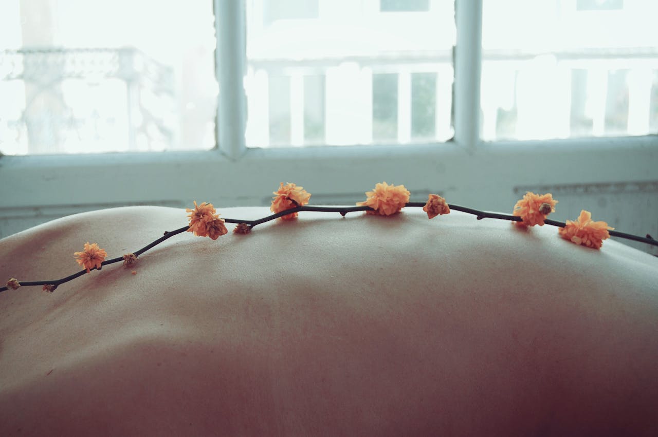 Orange Petaled Flowers on Persons Back